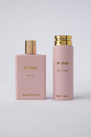 Two pink bottles with gold caps labeled 'Pink' on a light gray background by Atyab Al Marshoud.