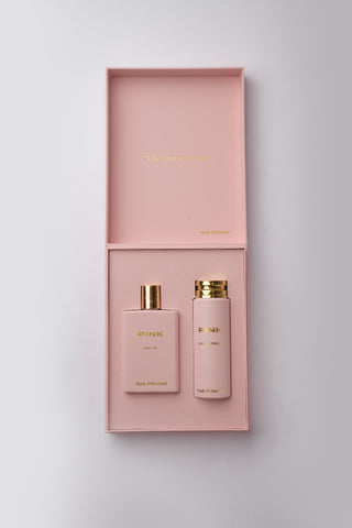 Pink perfume set with two bottles and a box on a light gray background by Atyab Al Marshoud.