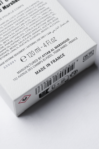 Close-up of a product packaging with text and branding details on a white background by Atyab Al Marshoud.