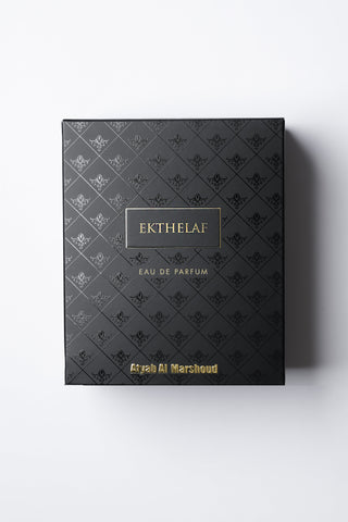 Black perfume box with 'Ekthelaf' branding on a white background by Atyab Al Marshoud.