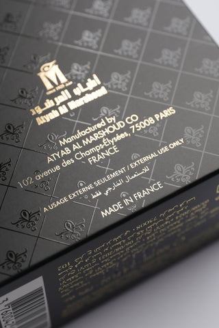 Close-up of a product packaging with gold text on a dark background by Atyab Al Marshoud.
