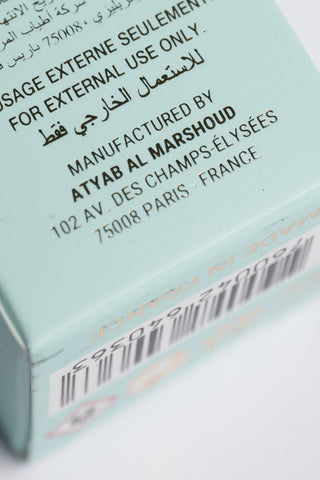 Product packaging with text and a barcode on a light blue background by Atyab Al Marshoud.