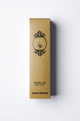 Gold hair mist packaging with decorative design on a white background by Atyab Al Marshoud.