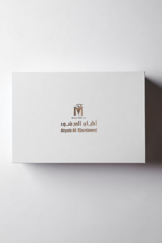 White box with branding on a white background by Atyab Al Marshoud.