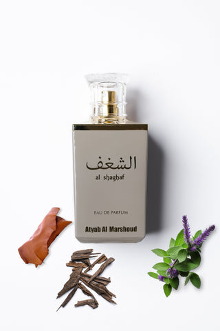 Perfume bottle labeled 'al shaghaf' with natural elements on a white background by Atyab Al Marshoud.