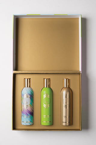 Three decorative bottles in a gold box on a white background by Atyab Al Marshoud.