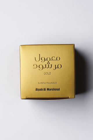 Gold box with Arabic text and 'Atyeh Al Marshoud' branding on a light gray background by Atyab Al Marshoud.